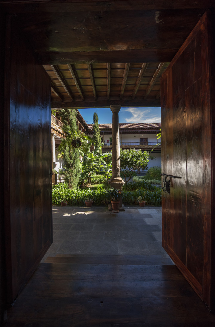 Interior courtyard with plants and columns, seen from a door in La Laguna, Tenerife.
