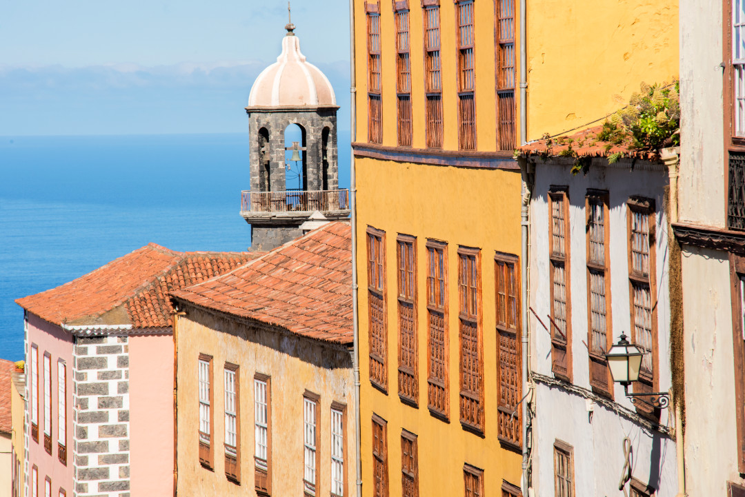 Colorful houses and tower with sea view in La Orotava, Tenerife.