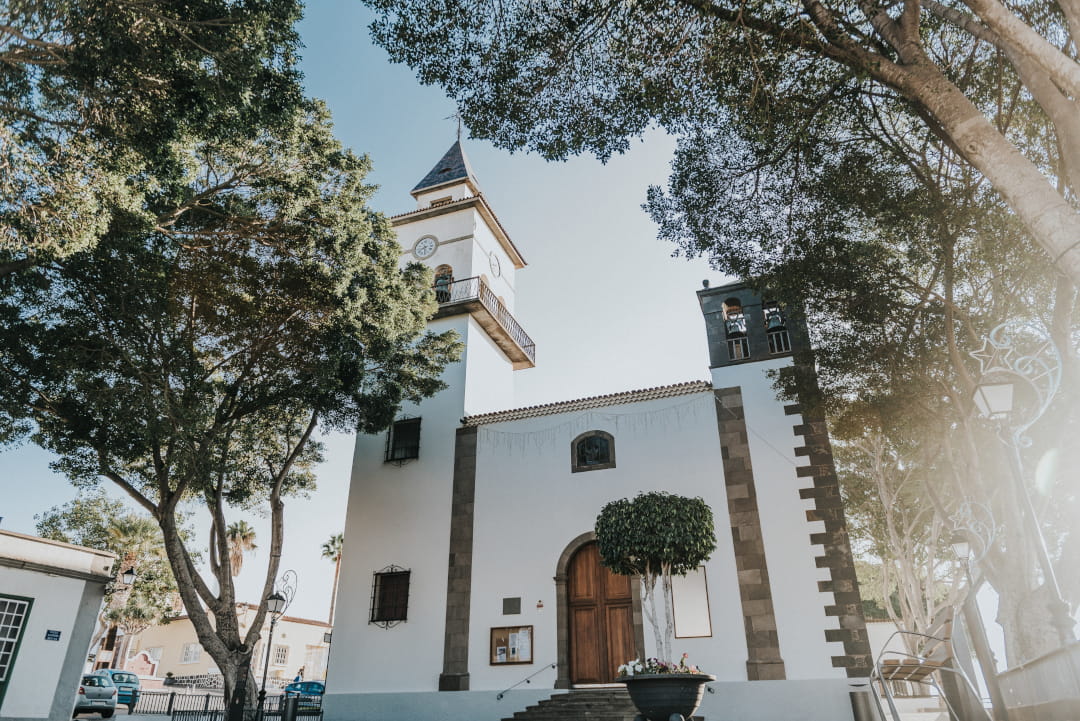 Church surrounded by trees on a sunny day in Tenerife.