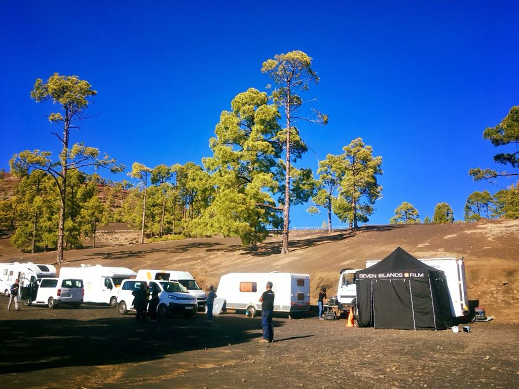 SEVEN ISLANDS FILM caravan area and tent under pine trees in Tenerife.