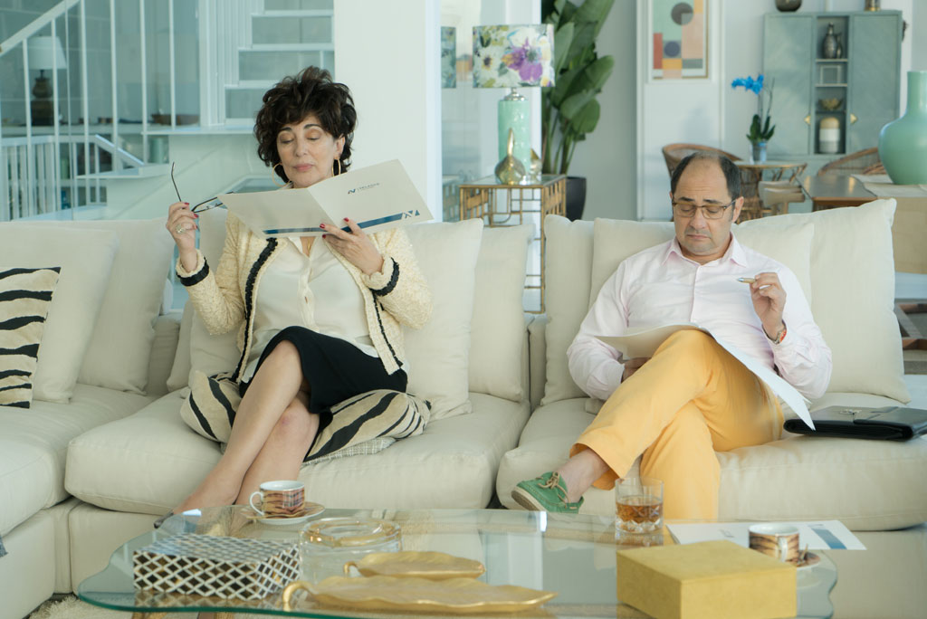 Two people sitting on a sofa reading documents in Tenerife.