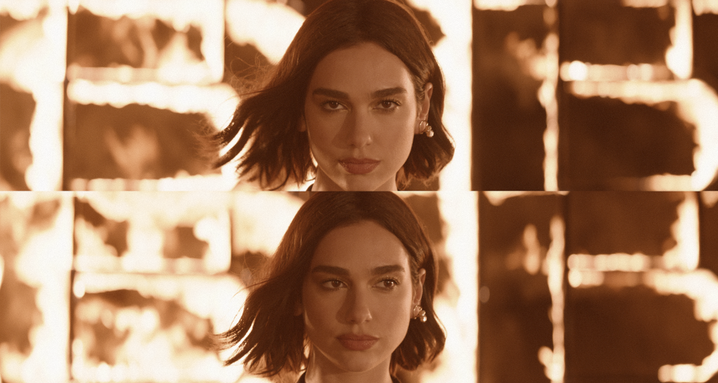 Close-up of a woman with short hair in front of a background lit by flames, in a cinematic tone.