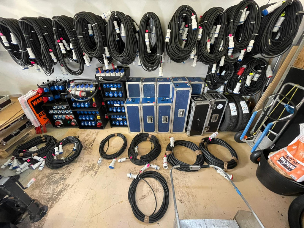 Cables and boxes of electrical equipment organized in a warehouse in Tenerife.