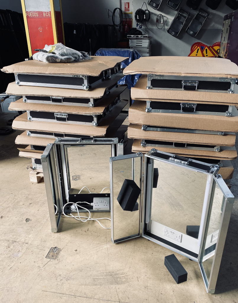 Stacked suitcases and mirror with power outlet in a warehouse in Tenerife.