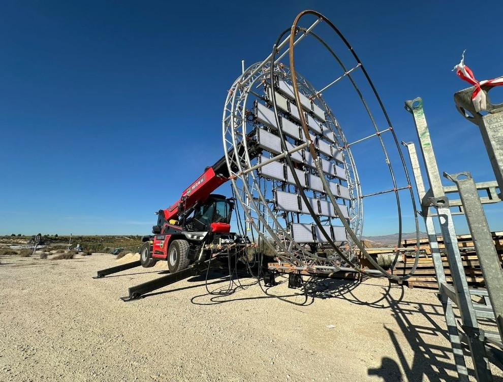Crane assembling circular metal structure in Tenerife.