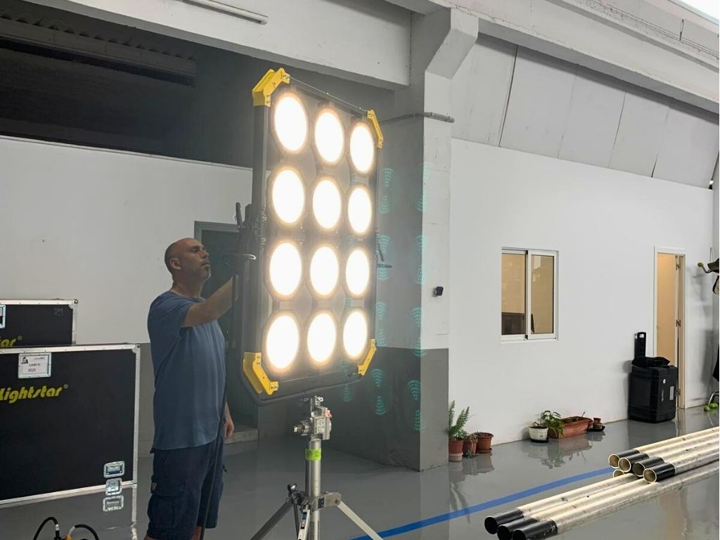 Man adjusting large lamp in production studio in Tenerife.