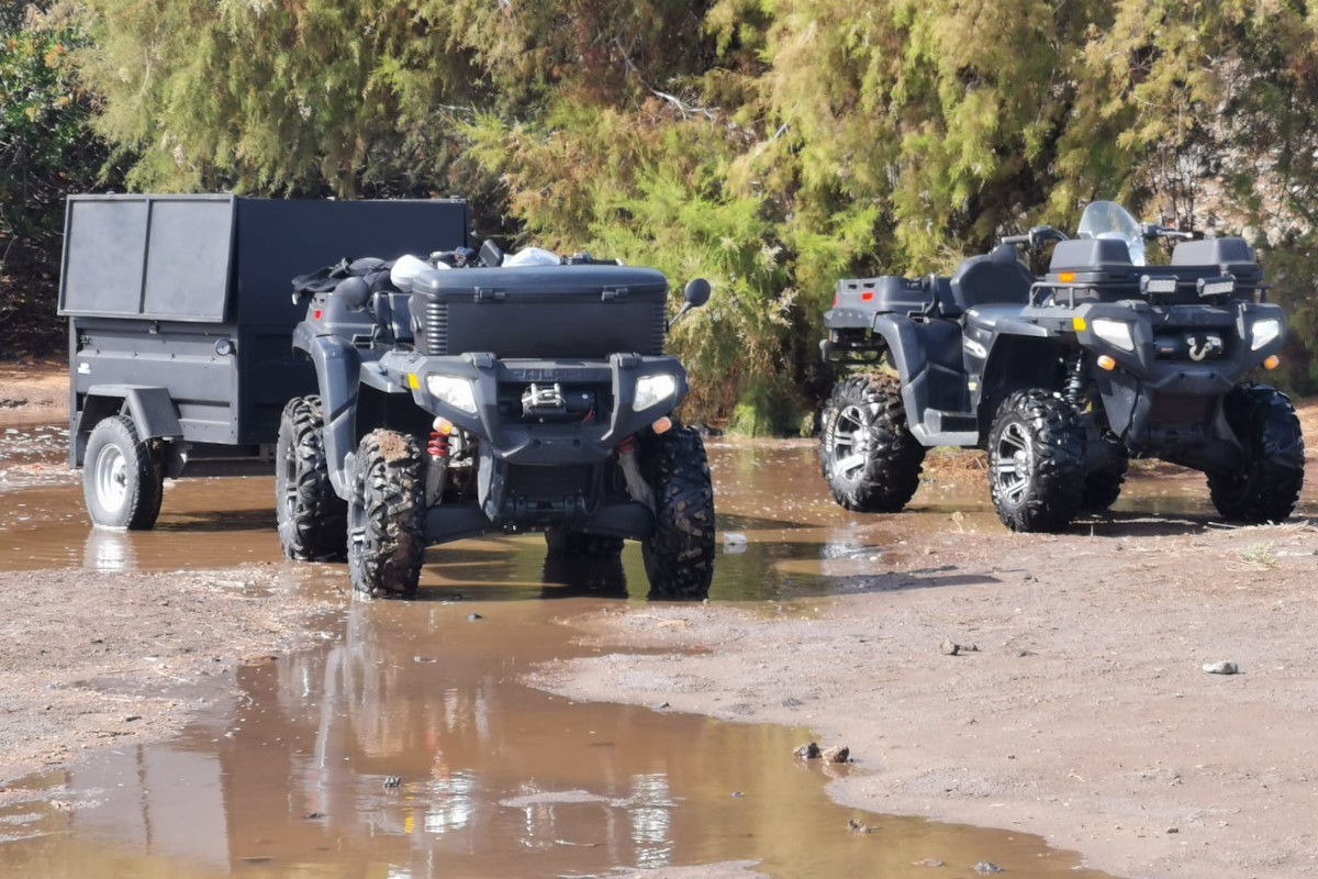 ATVs crossing a muddy road in Tenerife.