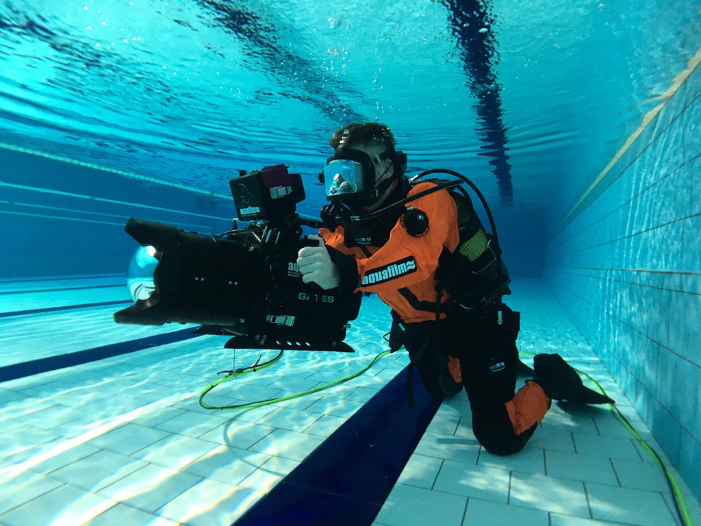 Diver with underwater camera in a swimming pool in Tenerife.