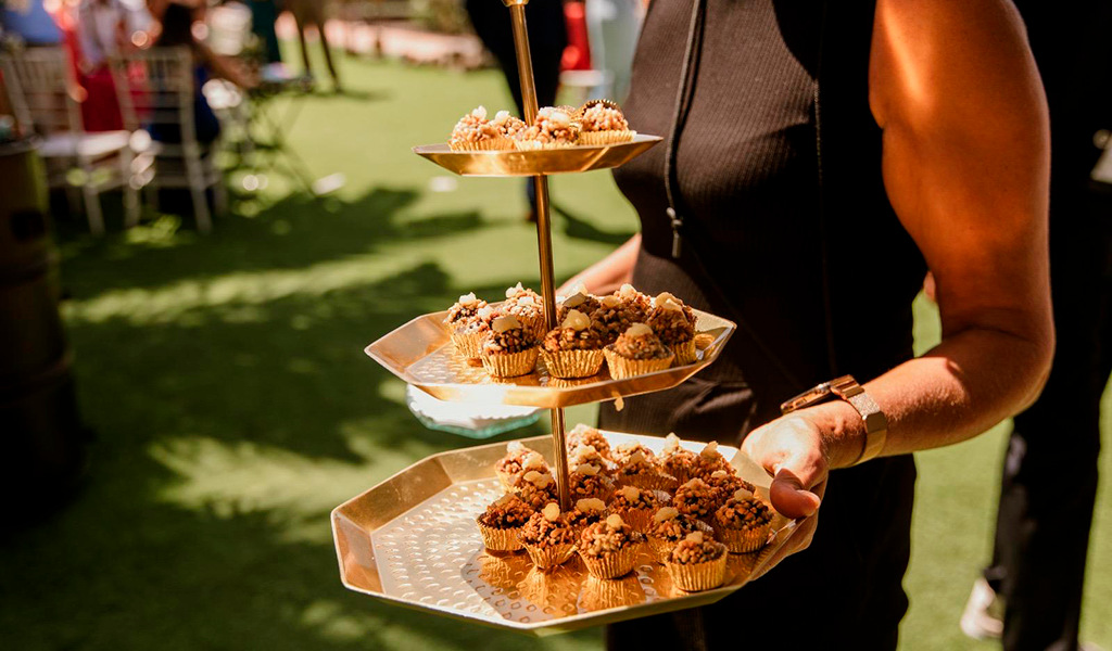 Sweets on a golden platter at an event in a garden in Tenerife.