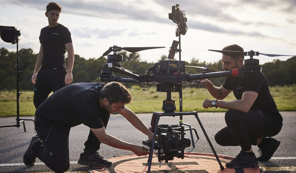 Technicians adjusting a drone in a field in Tenerife.