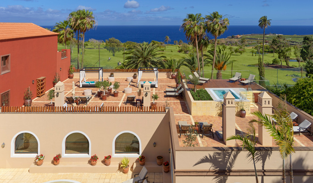 Terrace with chairs and plants overlooking the sea in Tenerife.