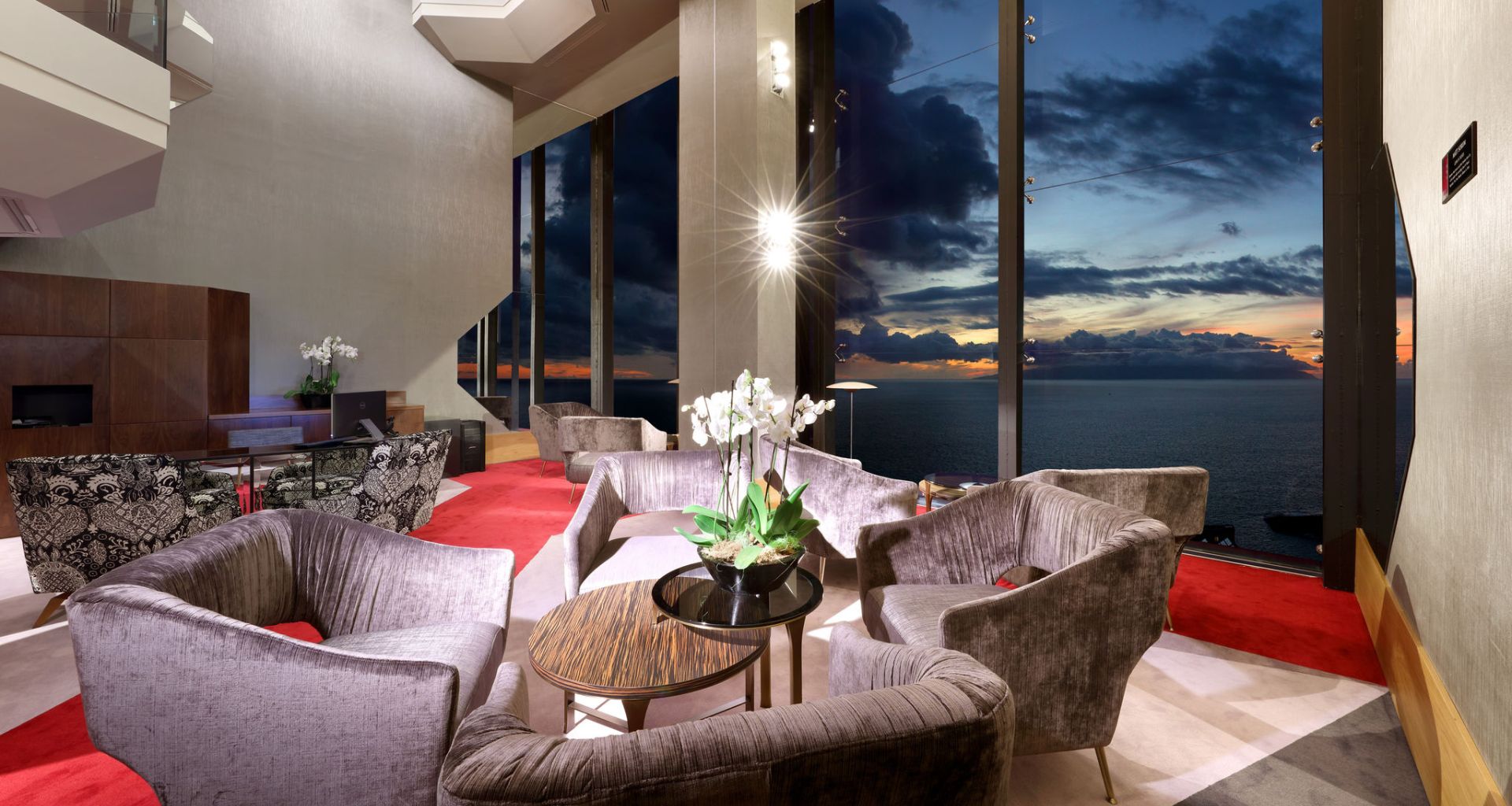 Modern living room with armchairs and sea view at sunset in Tenerife.
