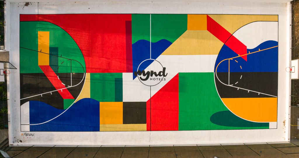 Colorful mural art with geometric shapes and text mynd hotels, in Tenerife.