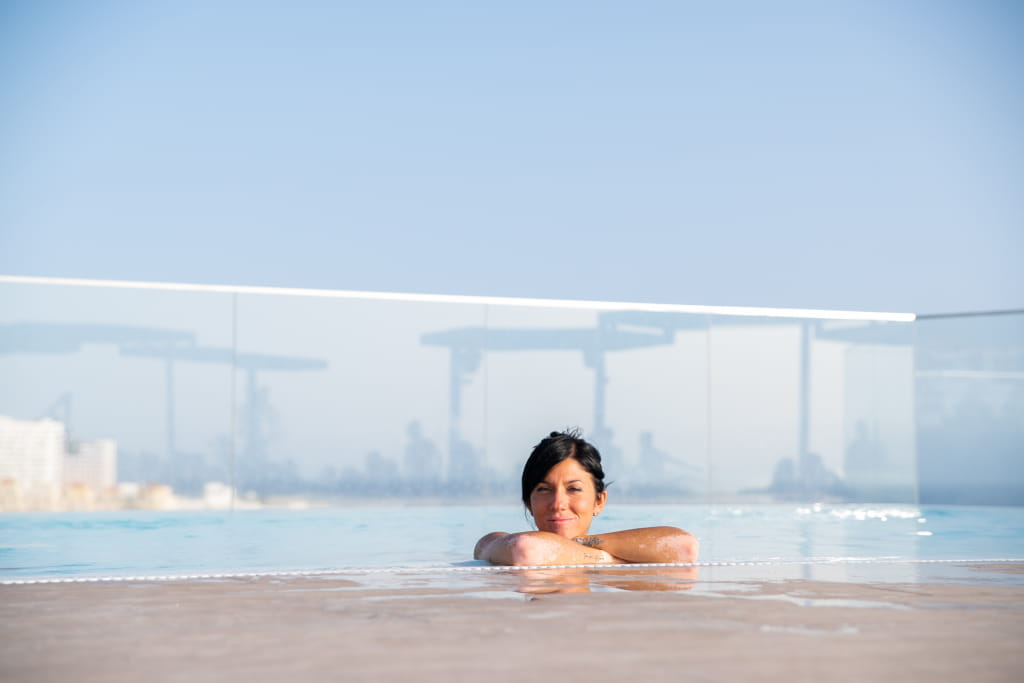 Person enjoying a swimming pool in a hotel in Tenerife.