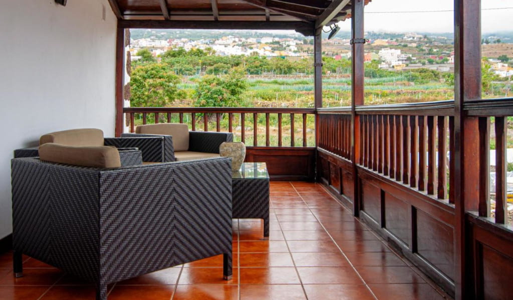 Terrace with wicker furniture and views of the countryside in Tenerife.