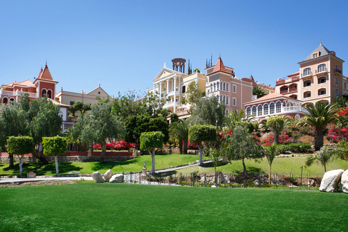 Colourful buildings surrounded by gardens and palm trees in Tenerife.
