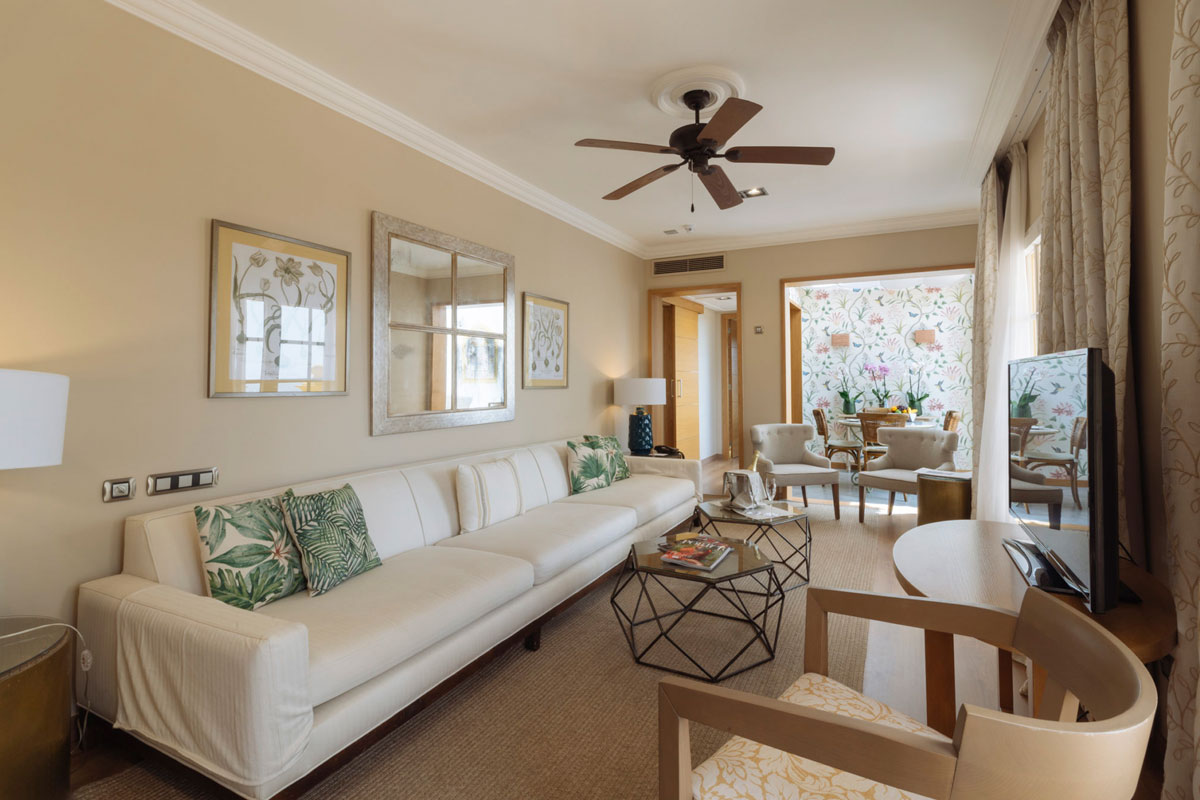 Living room with white sofa, coffee table and ceiling fan in hotel in Tenerife.