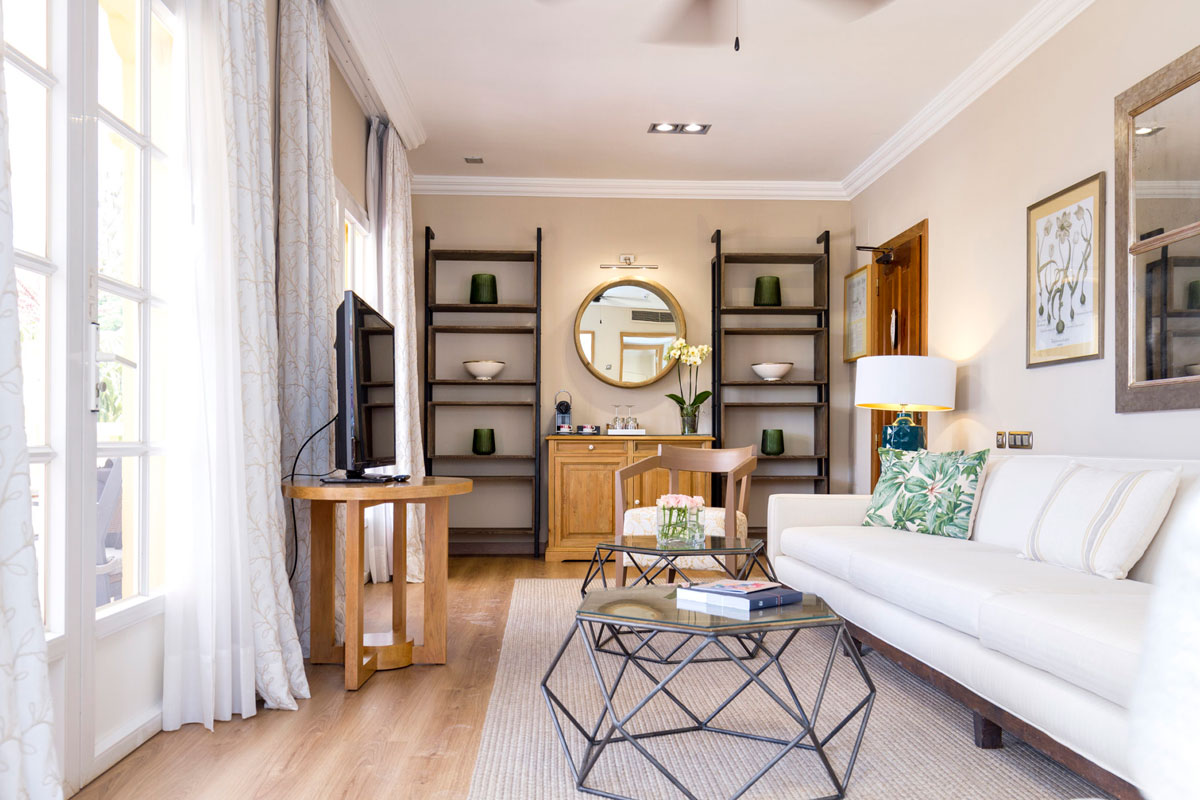 Bright living room with white sofa, bookshelves and mirror in Tenerife.