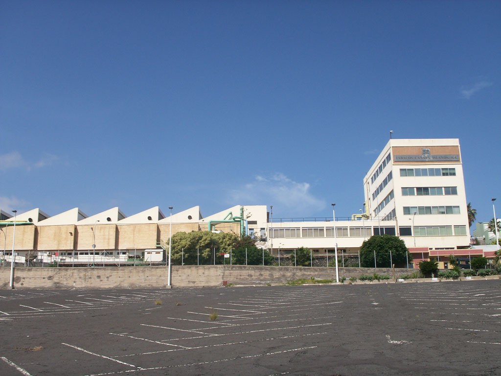 Industrial building next to empty parking lot in Santa Cruz de Tenerife.