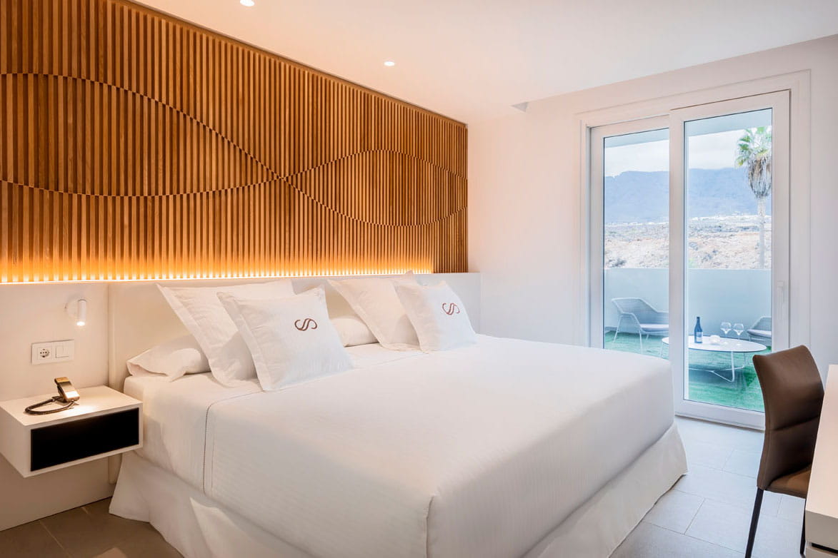 Hotel room in Tenerife with double bed, terrace and exterior view.