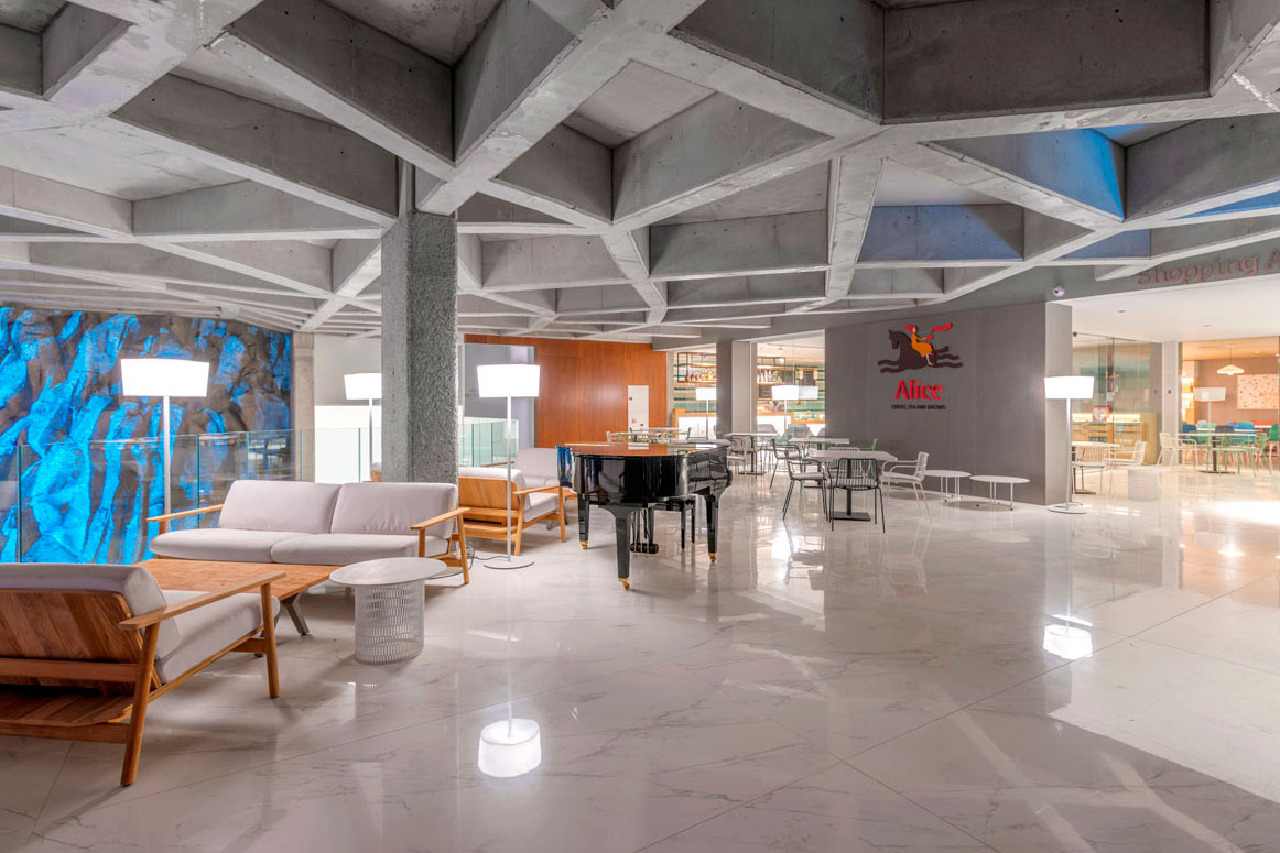 Modern lobby with geometric ceiling and piano in Afiche shopping centre, Tenerife.