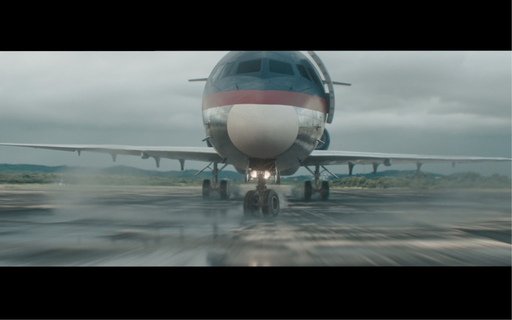 Plane taking off on a runway under cloudy skies in Tenerife.