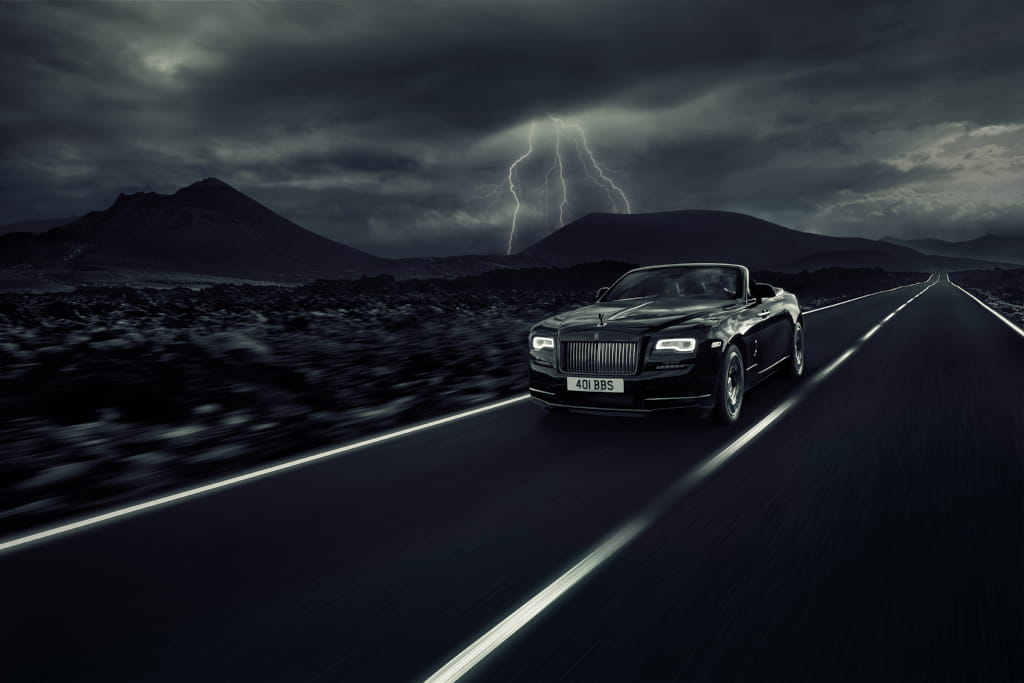 Black car on road at night with lightning in Tenerife.