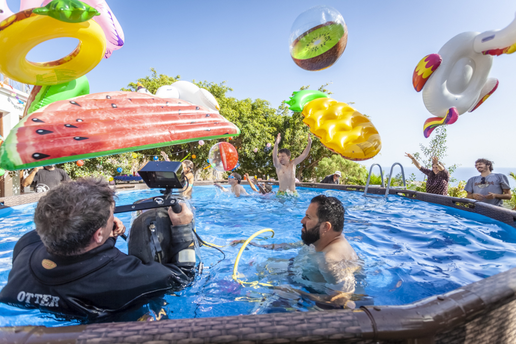 People in a pool with fruit floats in Tenerife. Submersible camera recording.