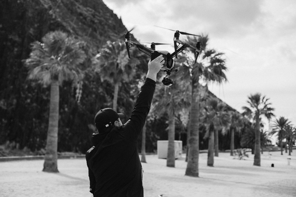 Person lifting a drone on the beach of Las Teresitas, Tenerife.