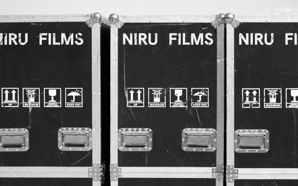 Transport boxes labeled Niru Films, with handling icons.
