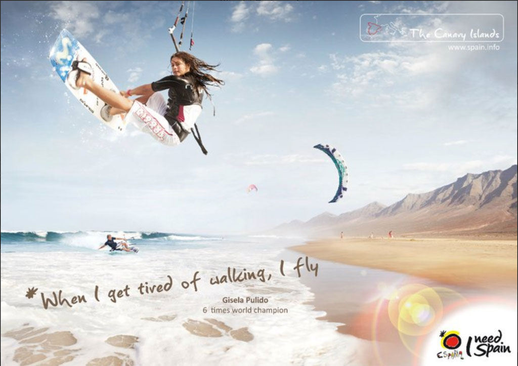 Person kitesurfing on the beach of Tenerife with mountains in the background. Text: When I get tired of walking, I fly.