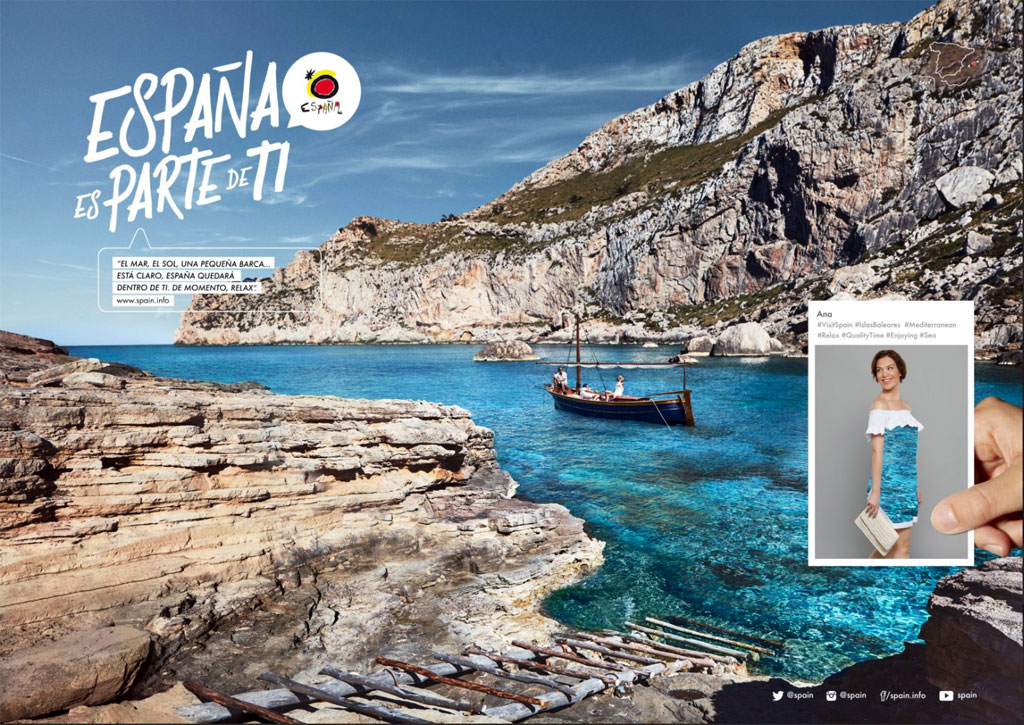Boat in crystal clear waters with rocky cliffs in the background. Text: Spain is part of you.
