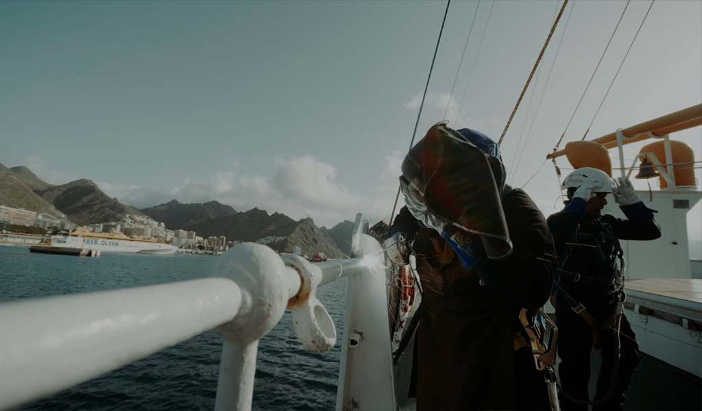 People working on the deck of a ship in the port of Santa Cruz de Tenerife.
