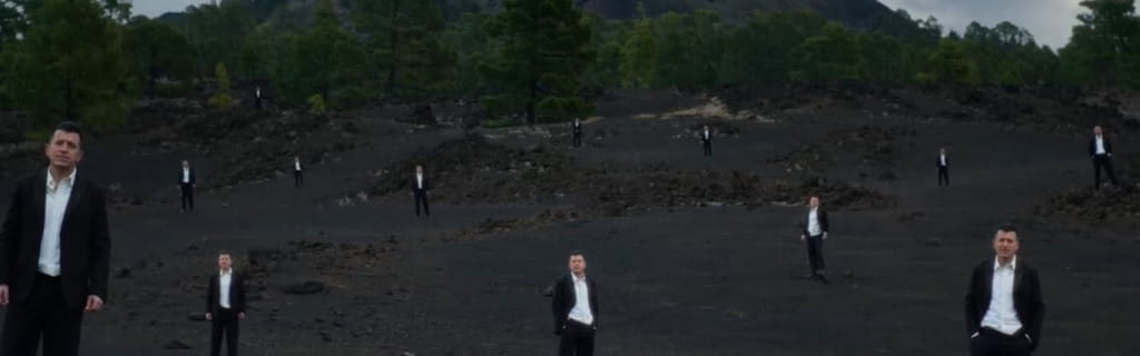 Several people in suits on volcanic terrain in Tenerife.