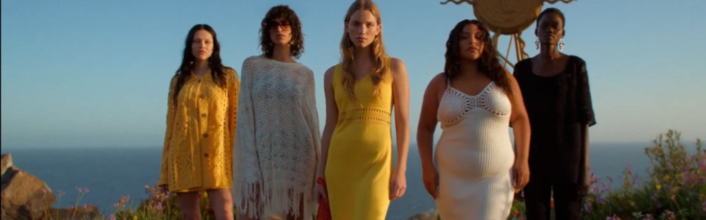 Five people in colorful dresses standing in front of the sea in Tenerife.