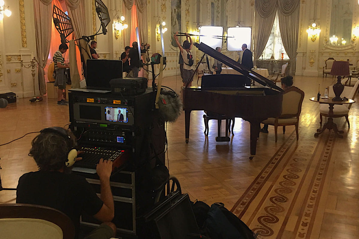 Filming in an elegant room in Tenerife with sound system and grand piano.