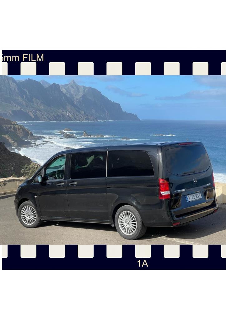 Van negra parked in front of the sea and mountains in Tenerife. Plate: 1725 KXT.