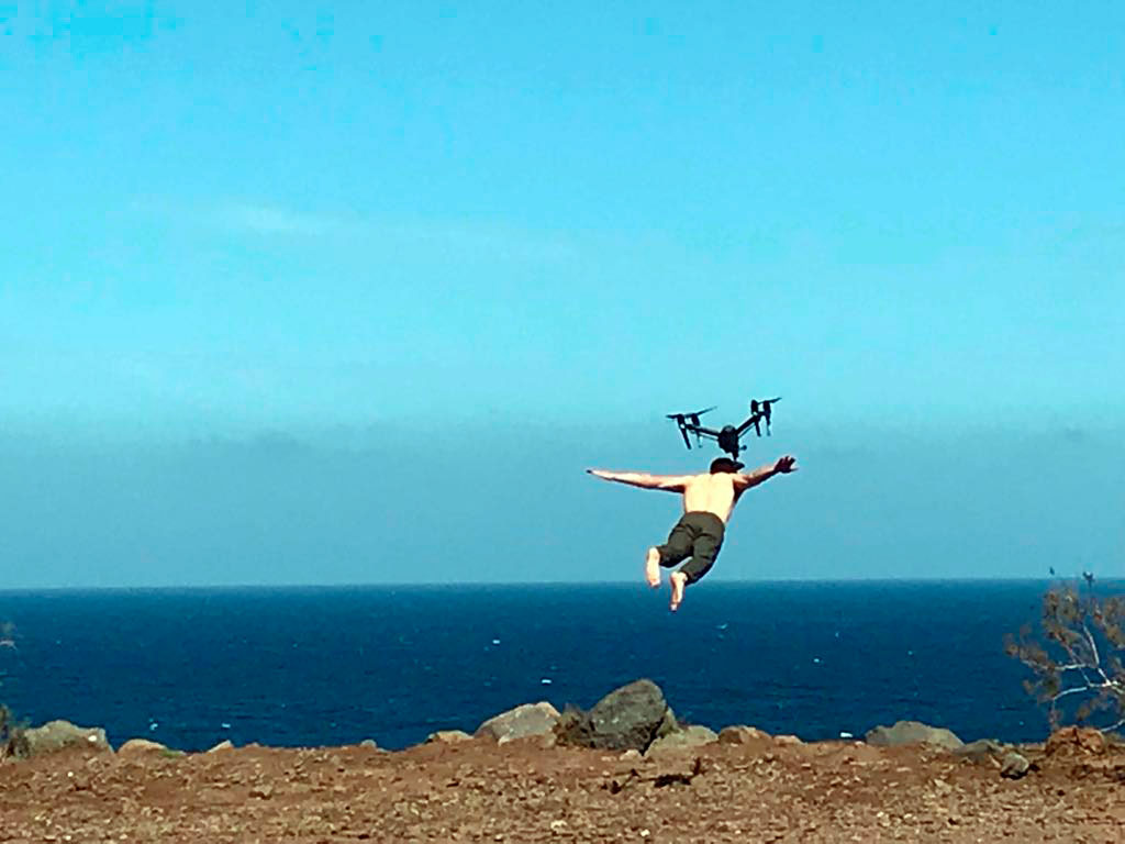 Person jumping with drone over the sea in Tenerife.