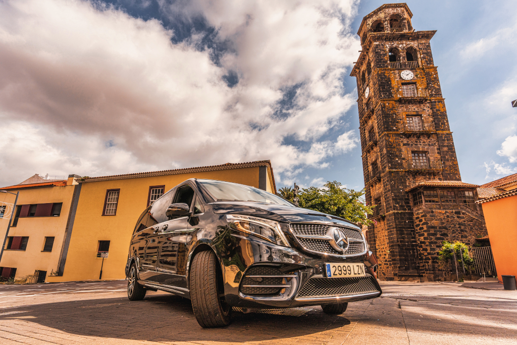 Black car in front of historic tower in San Cristóbal de La Laguna, Tenerife.