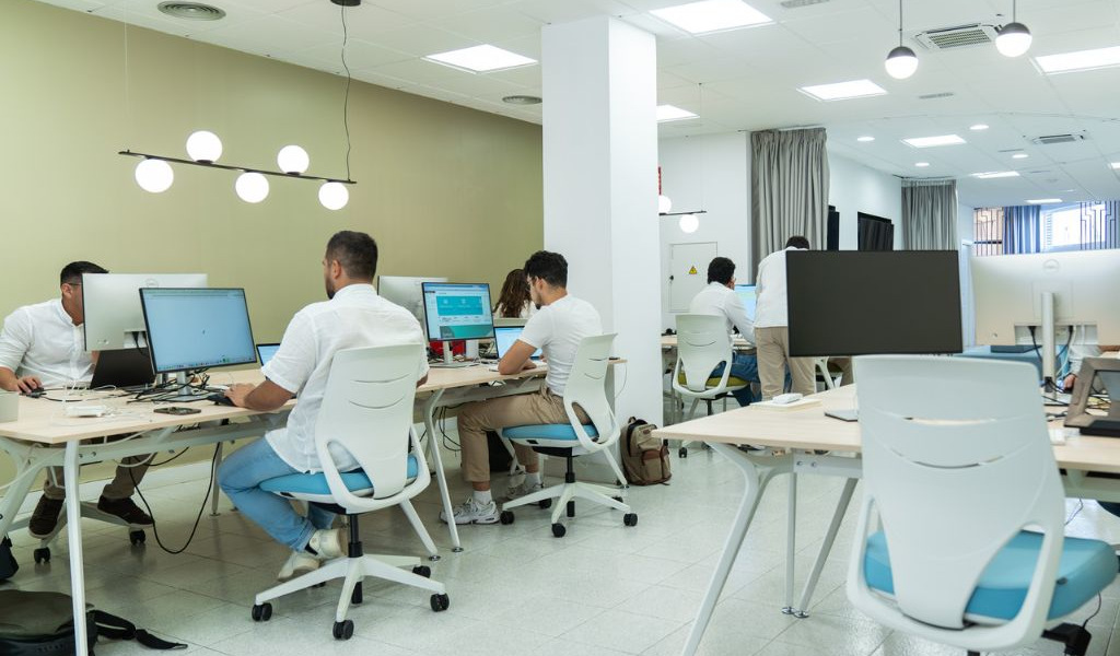 People working on computers in a modern office in Tenerife.