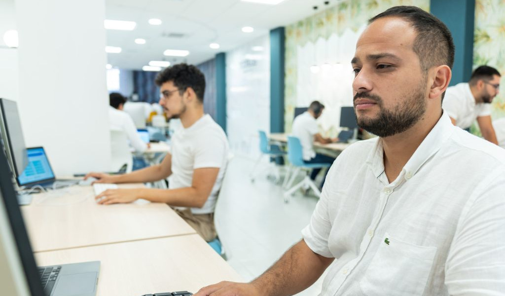 People working on computers in a modern office in Tenerife.