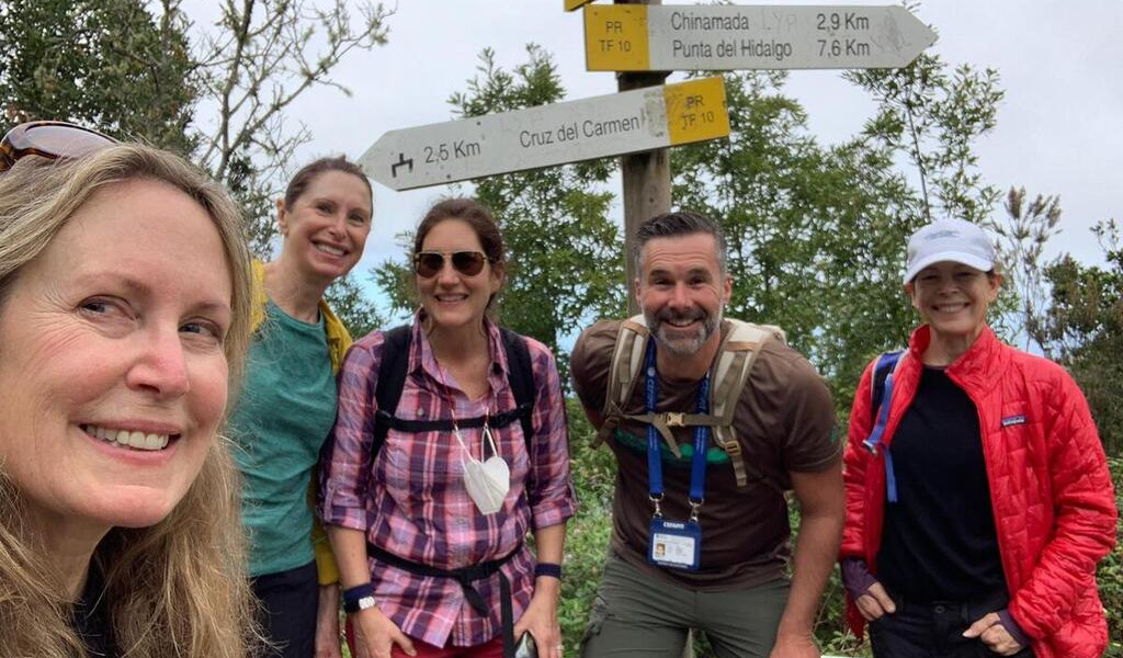 Group of hikers at a signpost near Cruz del Carmen, Tenerife hiking trail.