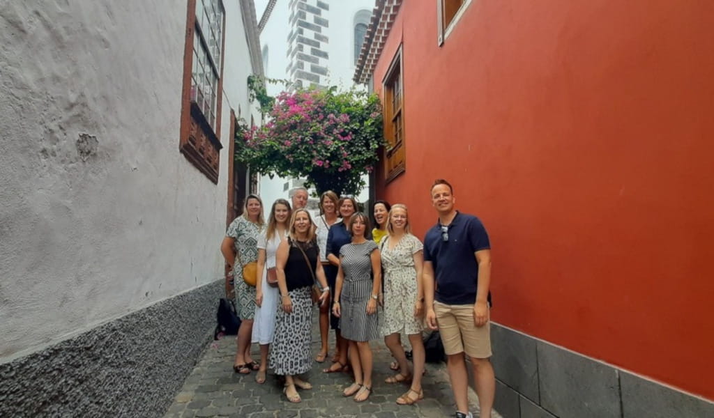 Group standing in a narrow alley with colorful walls in La Orotava, Tenerife.