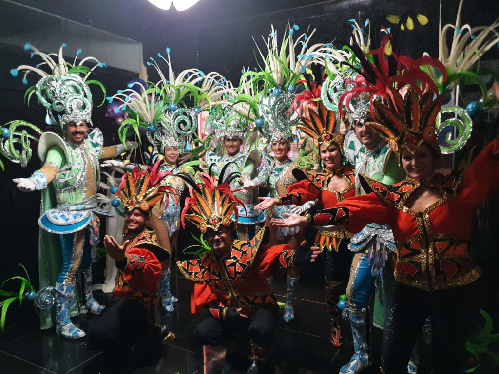 People in vibrant, colorful costumes at a Tenerife festival event.