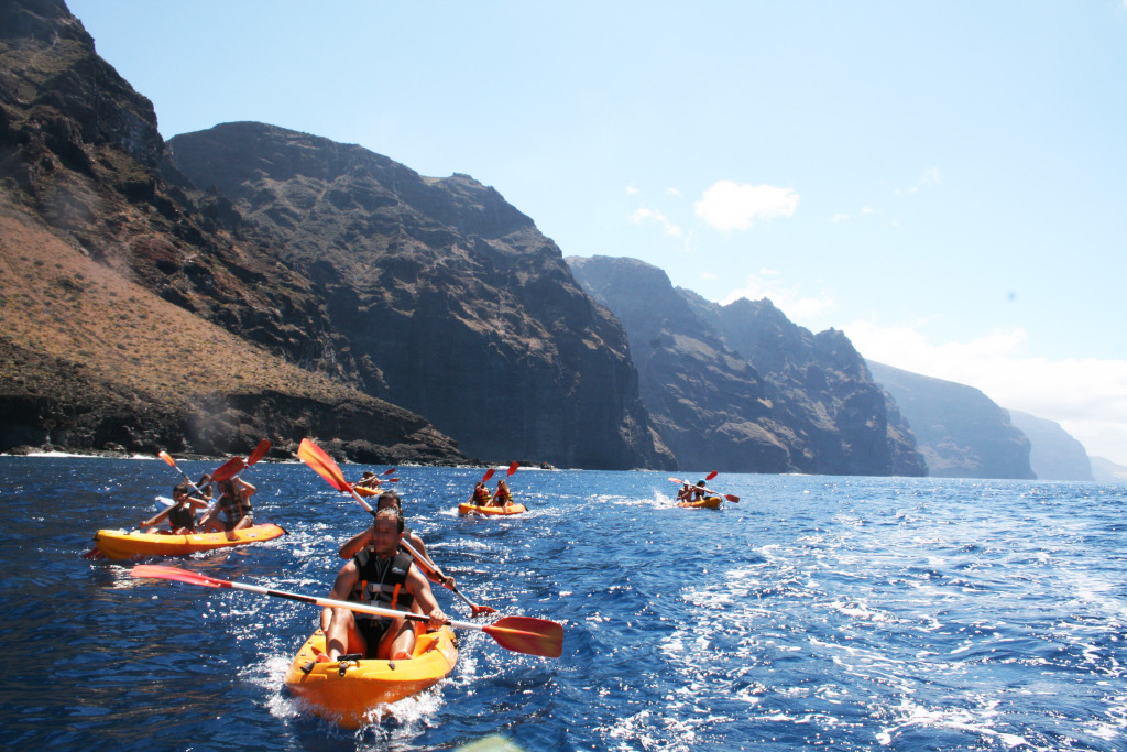 Kayakers paddling near Los Gigantes cliffs in Tenerife.
