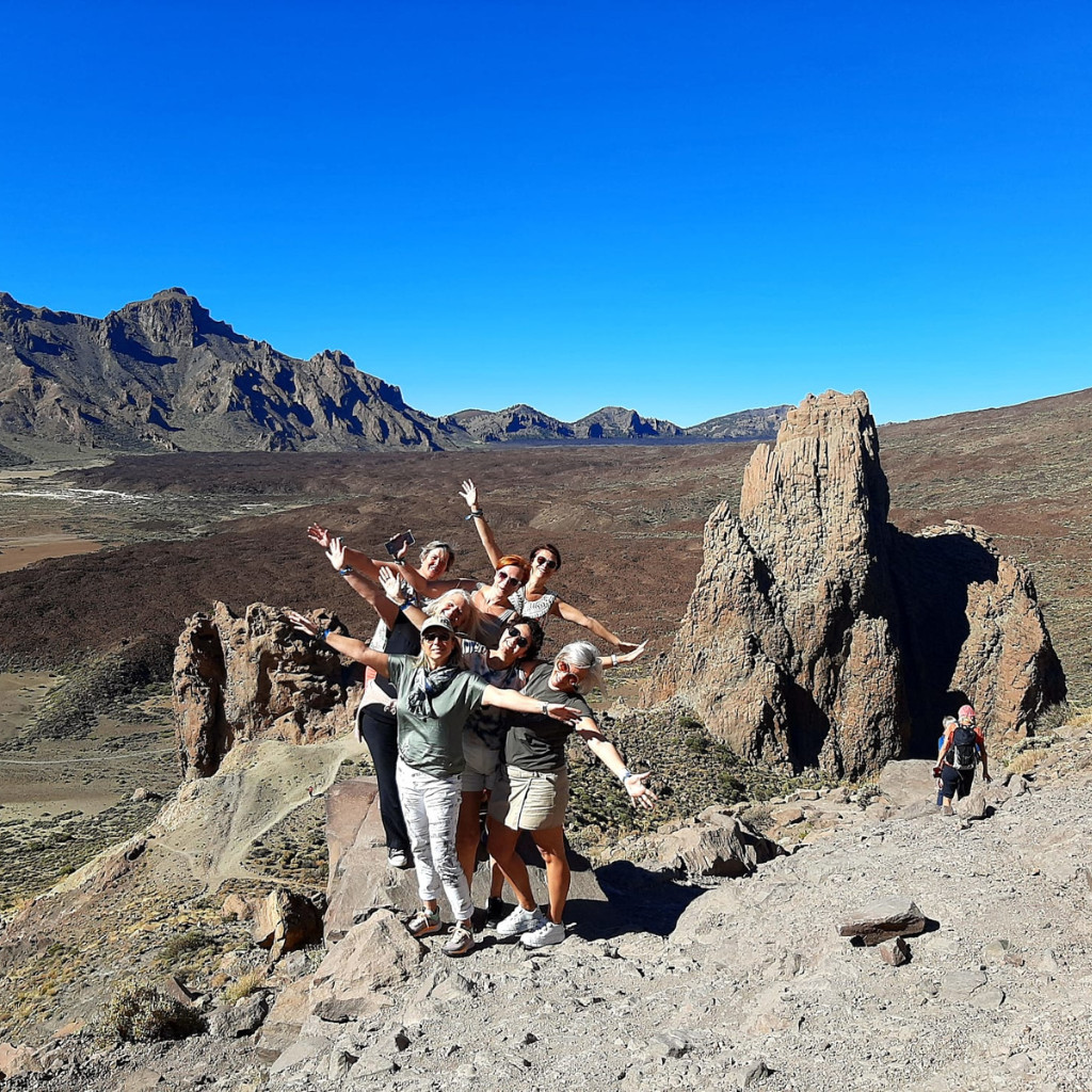 Group hiking at Roque Cinchado in Teide National Park, Tenerife.