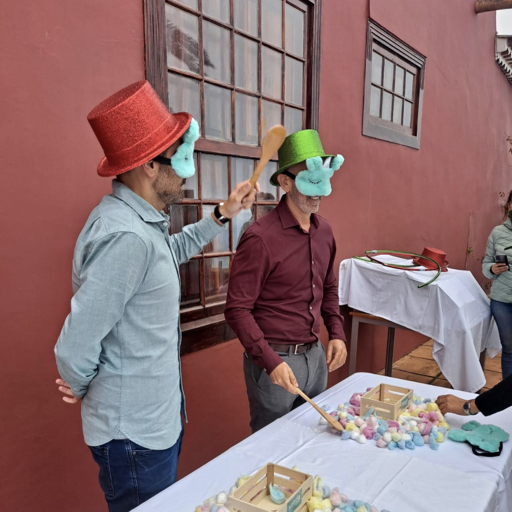 People wearing hats playing with spoons and colorful objects in Tenerife.