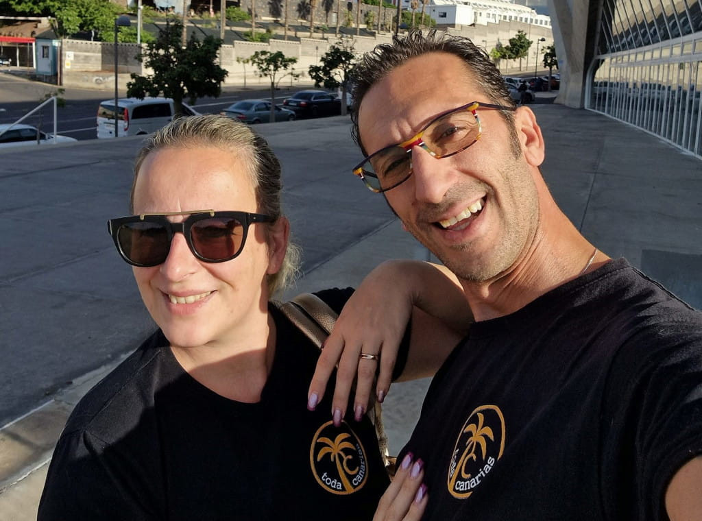 People smiling in Santa Cruz de Tenerife, wearing Canary Islands T-shirts.
