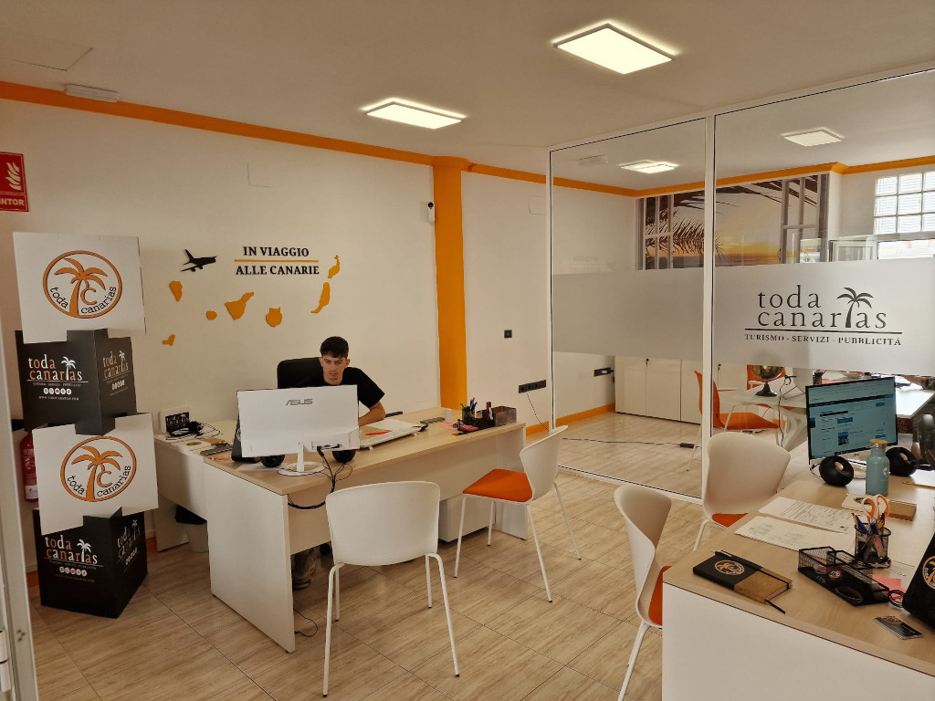 Office in Tenerife with 'In viaggio alle Canarie' decoration on the wall.