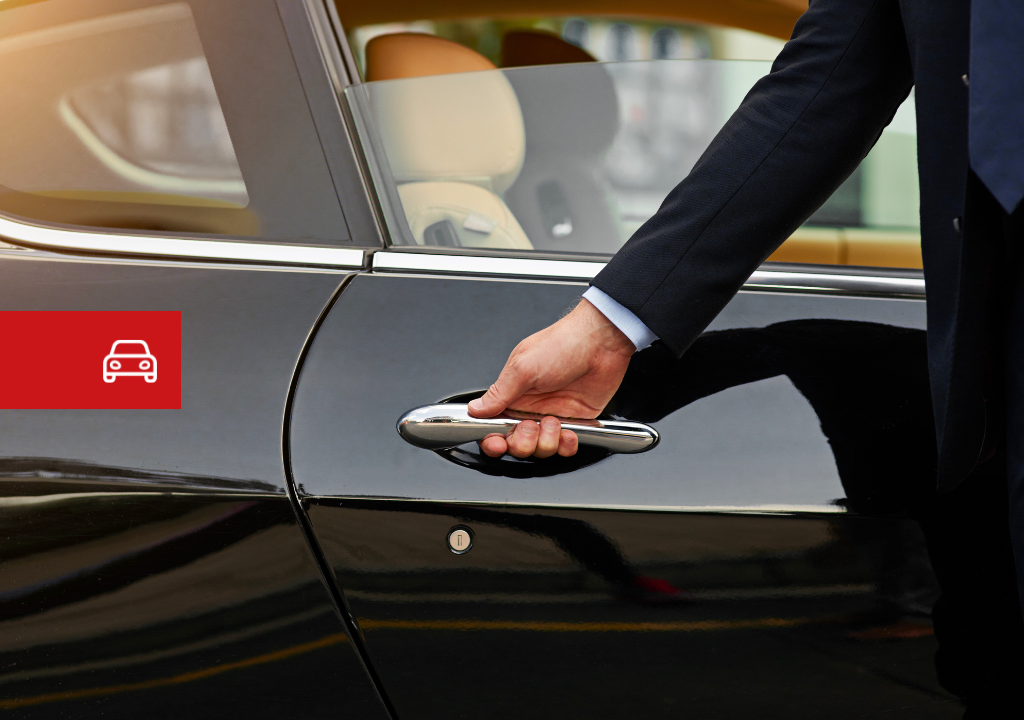 Hand opening the door of a black car in Tenerife. Red car icon visible.